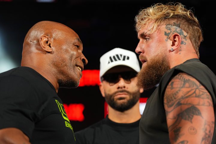 Mike Tyson and Jake Paul stare in a face-off.