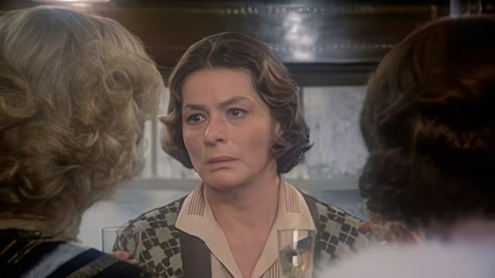A woman pleads with two other women in Murder on the Orient Express.