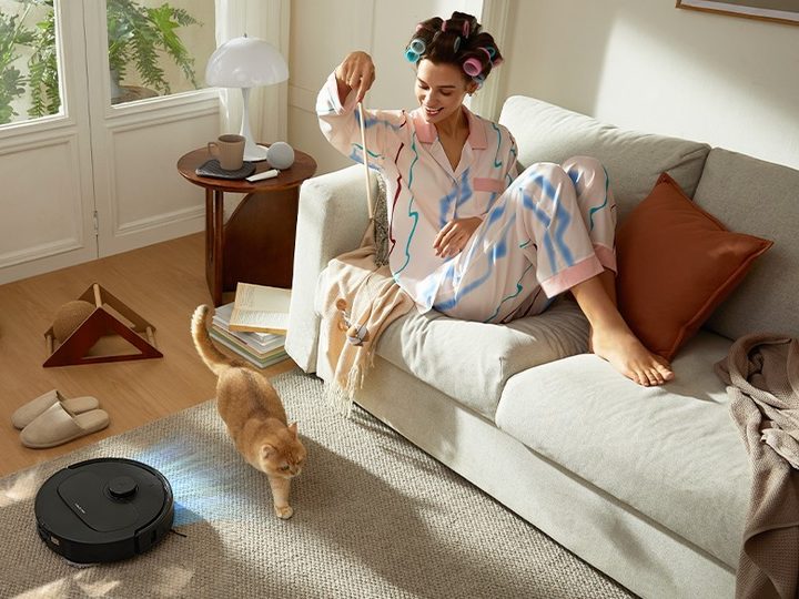 Roborock QRevo S cleaning with cat and pet owner nearby