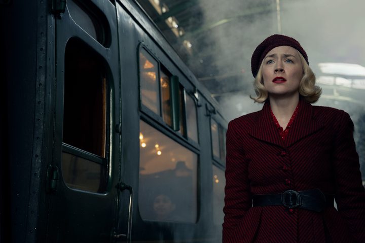 Saoirse Ronan stands next to a train in Blitz.