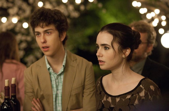A girl and boy stare at something in the same direction.