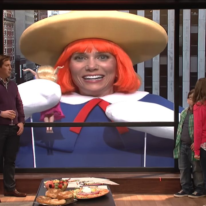 A family watching a parade float holding a woman in "Saturday Night Live."