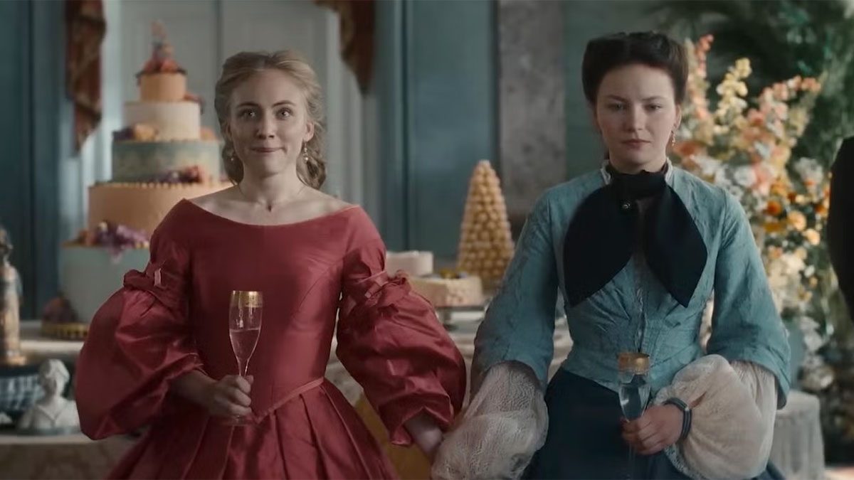 Two women hold hands in The Empress.