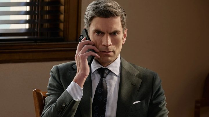 Wes Bentley holds a phone up to his ear in Yellowstone.