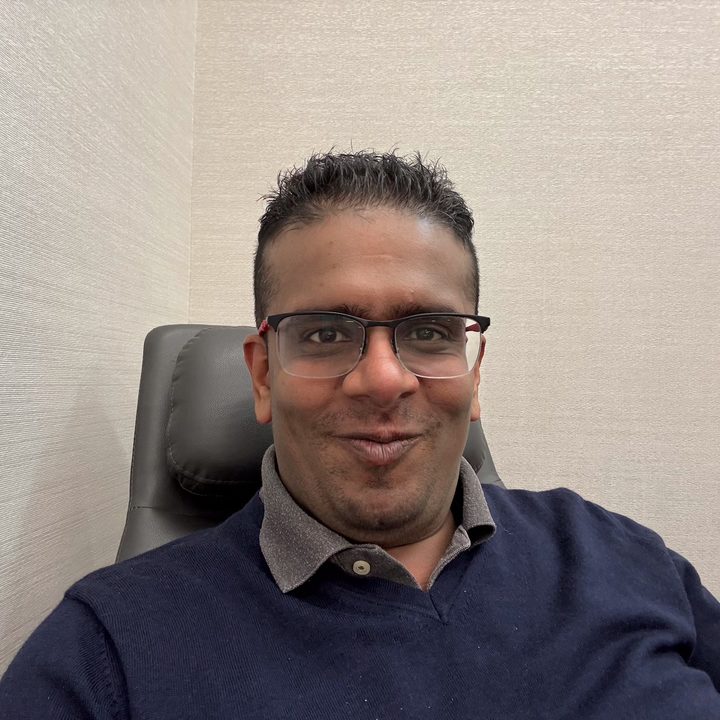 neutral background selfie captured on the iPhone 16 Pro.