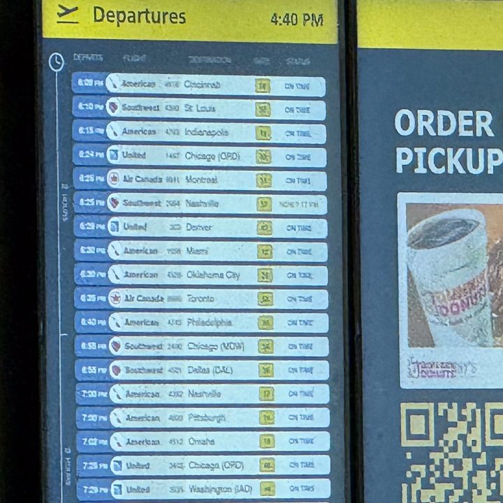 30x photo of an airport information board captured on the iPhone 16 Pro.