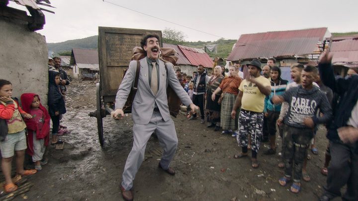 Borat carrying a large trailer on his back in Borat Subsequent Moviefilm.