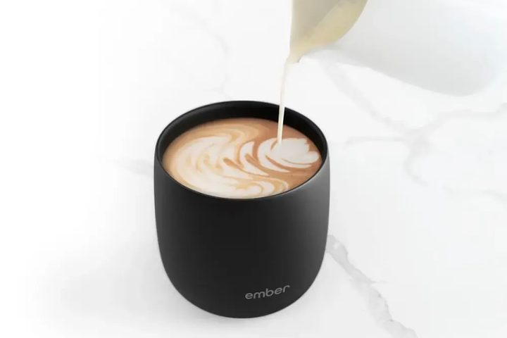 The Ember Temperature Control Smart Cup having creamer poured into it.