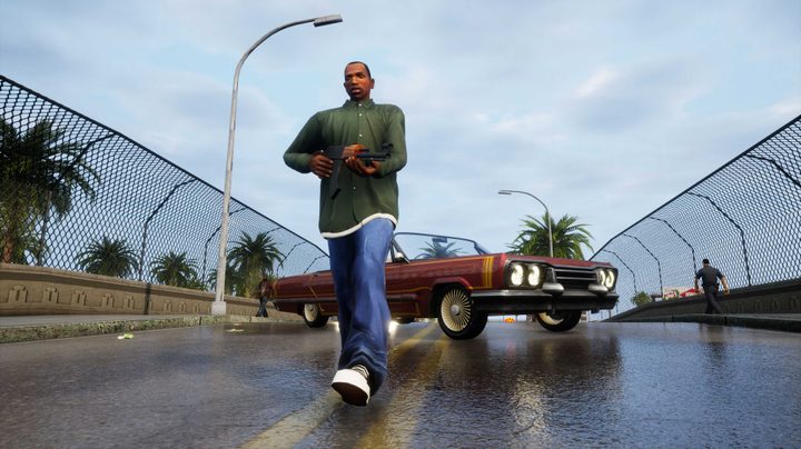Carl Johnson in a green shirt walking away from a car on a bridge. He's holding a gun.