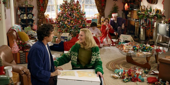 A family celebrates Christmas in Here.