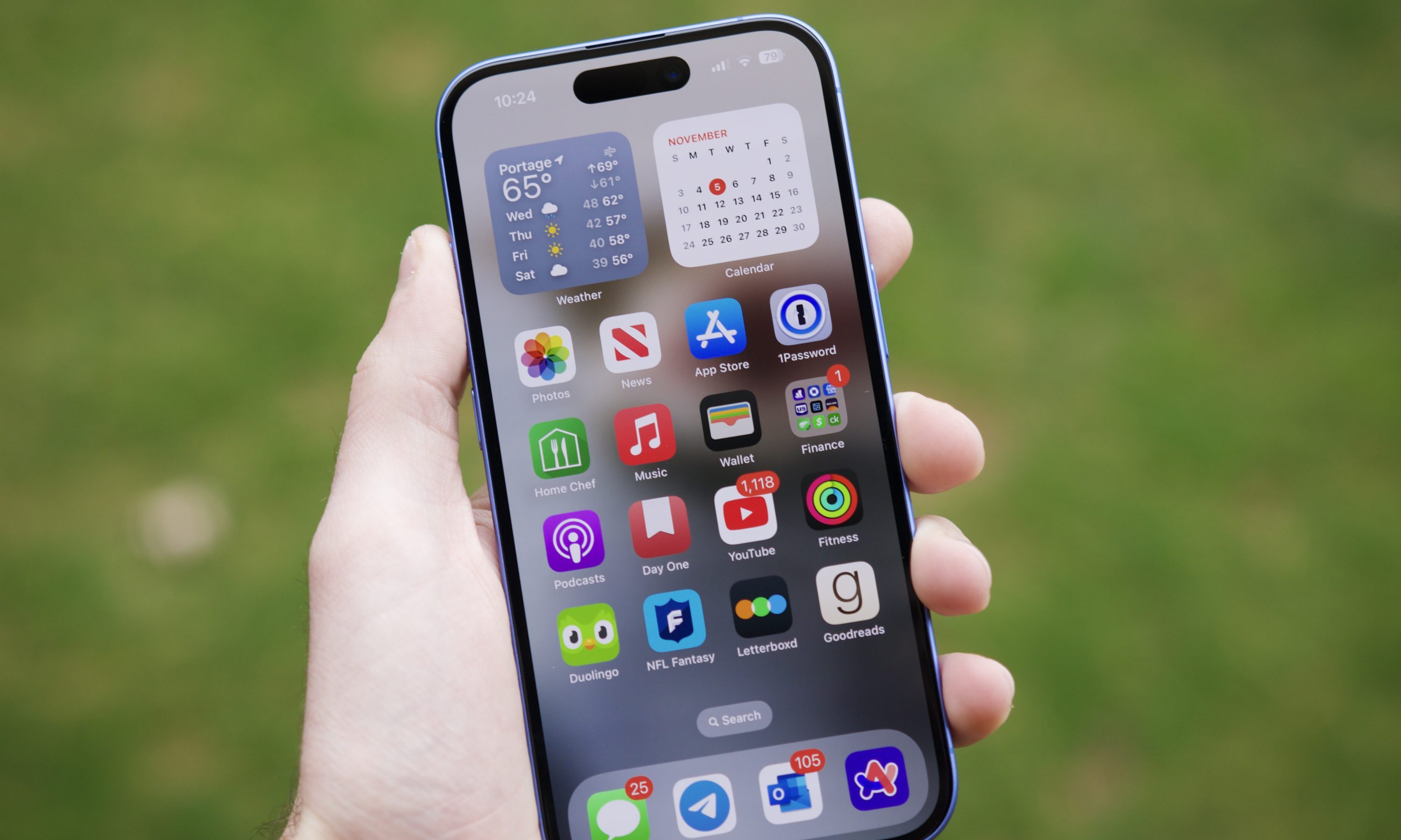Someone holding an iPhone 16, showing a home screen.