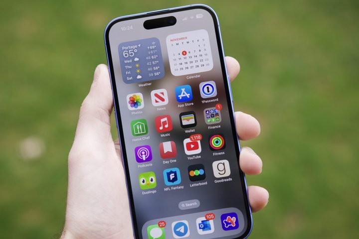 Someone holding an iPhone 16, showing a home screen.
