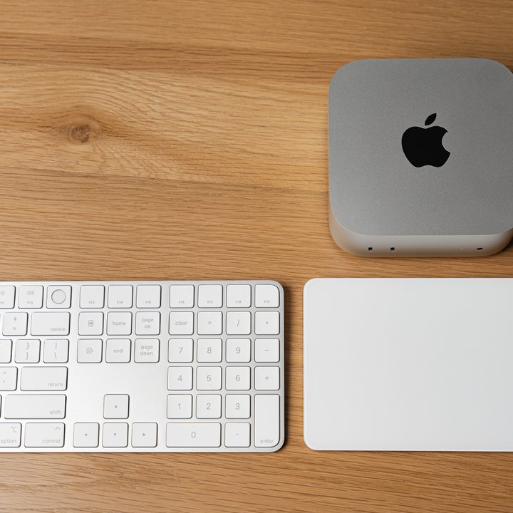 The Mac mini next to the Magic Keyboard and Magic Mouse.