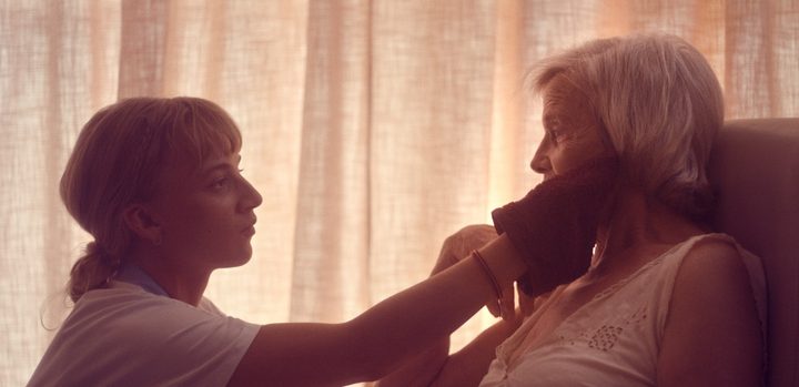 A woman touches an old woman's face in Meanwhile on Earth.