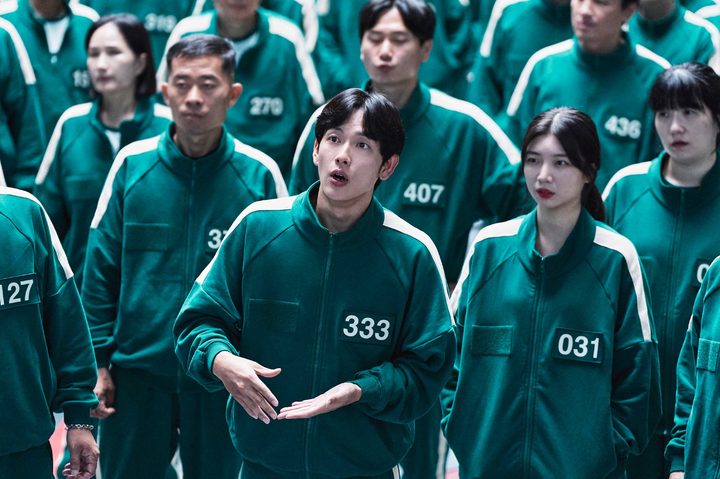 A group of people stand together in Squid Game season 2.