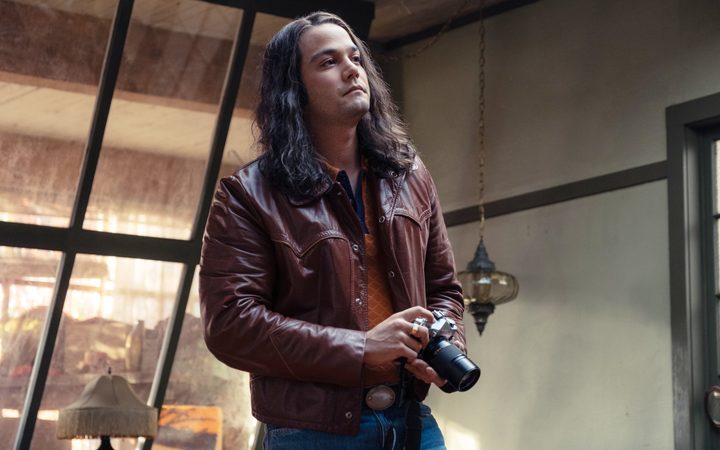 A man holds a camera in Woman of the Hour.