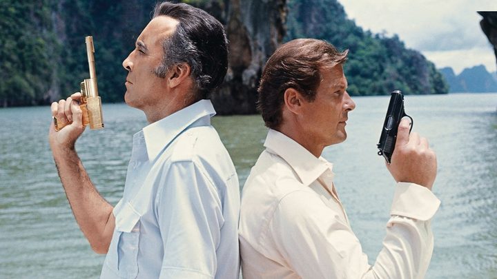 Christopher Lee and Roger Moore as Francisco Scaramaga and James Bond back to back holding pistols in The Man With the Golden Gun.