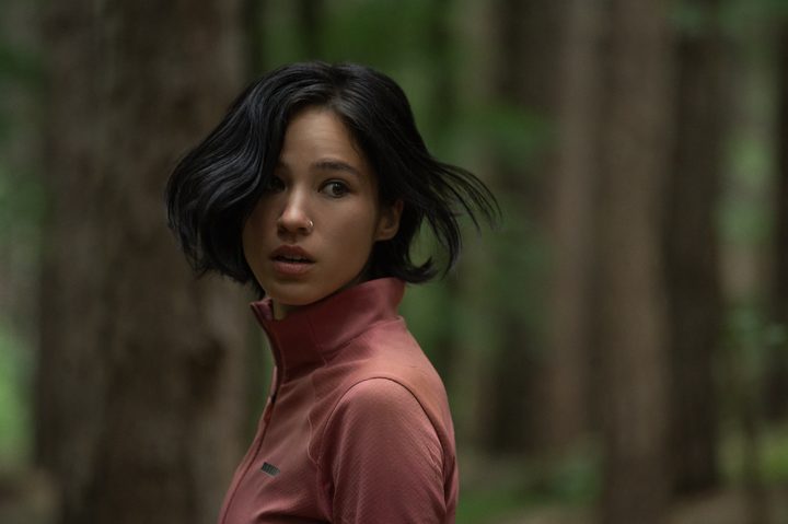 A woman looks back while walking in the woods in Don't Move.