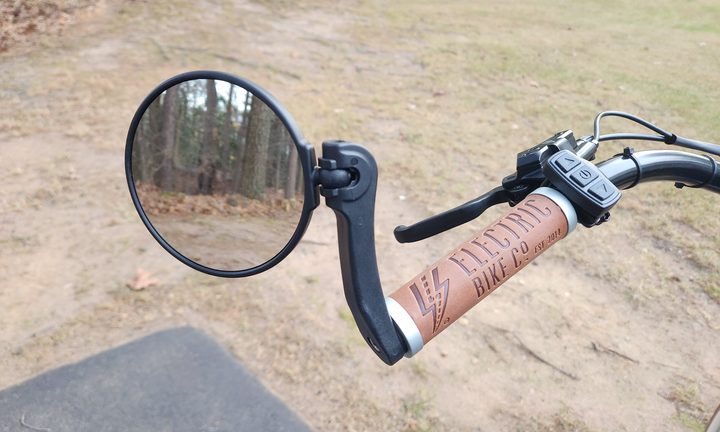 Electric Bike Company Model R left side of the handlebar with mirror, brake lever, and control pad.
