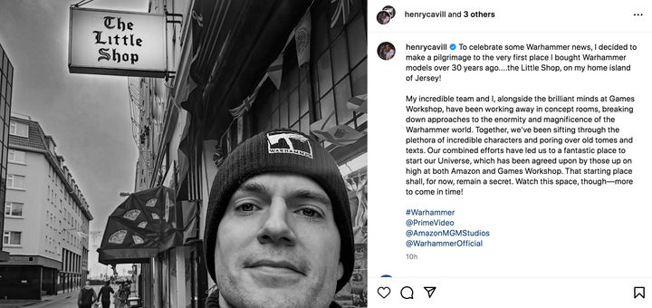 Henry Cavill poses for a selfie outside of a shop.