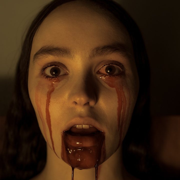 Lily-Rose Depp bleeds from the mouth and eyes in a still from the movie Nosferatu.