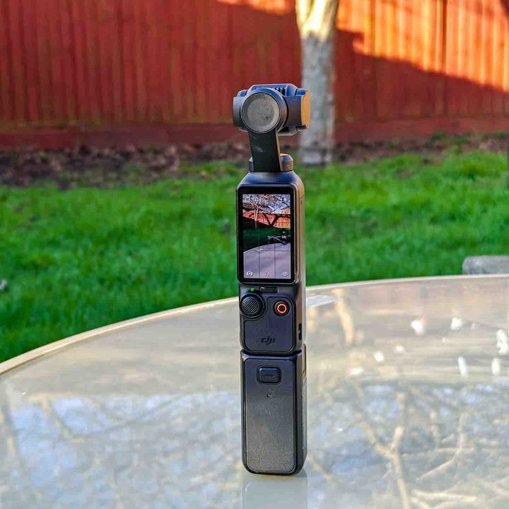 Osmo Pocket 3 on a table with the external battery pack attached