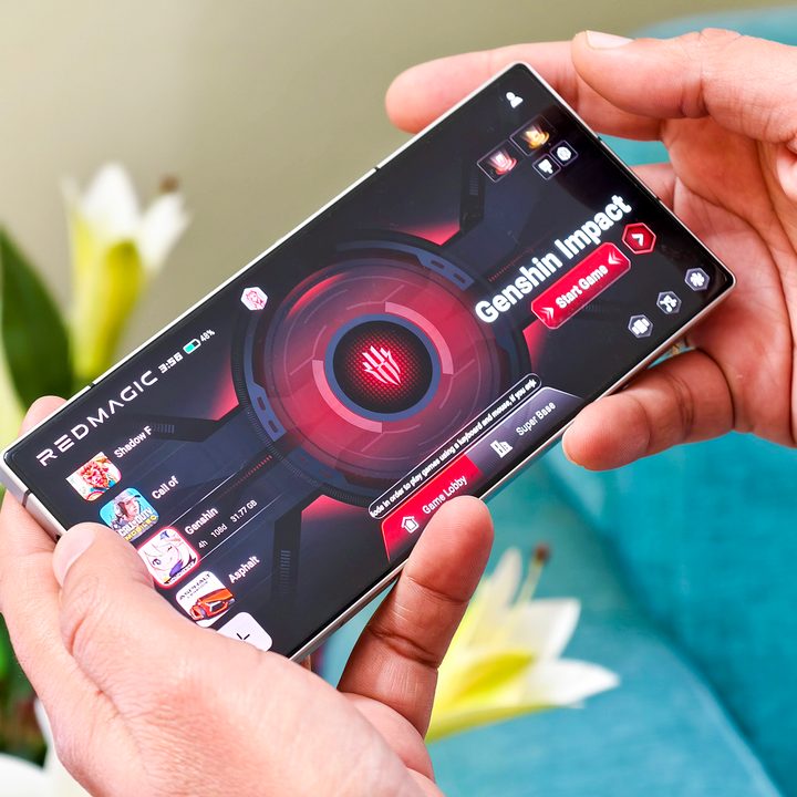 Redmagic 9S Pro Android gaming phone held in hand with game space Lobby running on it.