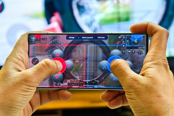 Redmagic 9S Pro Android gaming phone held in hands with virtual joystick for playing games like Call of Duty Mobile.