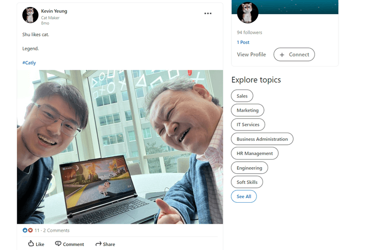 SuperAuthnti Co Co-creator Kevin Yeung poses with PlayStation's Shuhhei Yoshida in front of a laptop playing Catly.