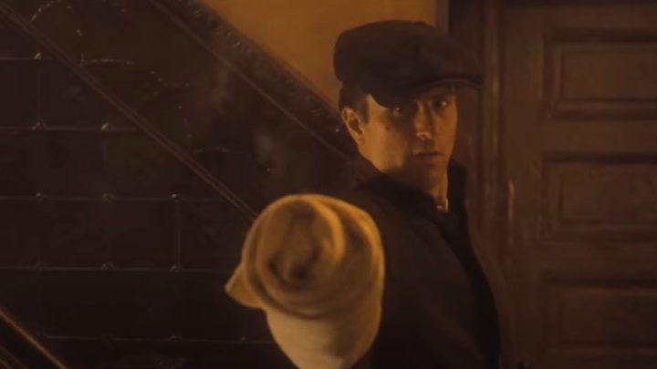 Robert De Niro aims a concealed weapon in The Godfather Part II.