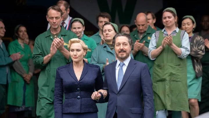 People clap for a couple in The Regime.