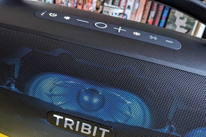 The Tribit Stormbox Blast 2 from the front. It is lit in blue LED lights.