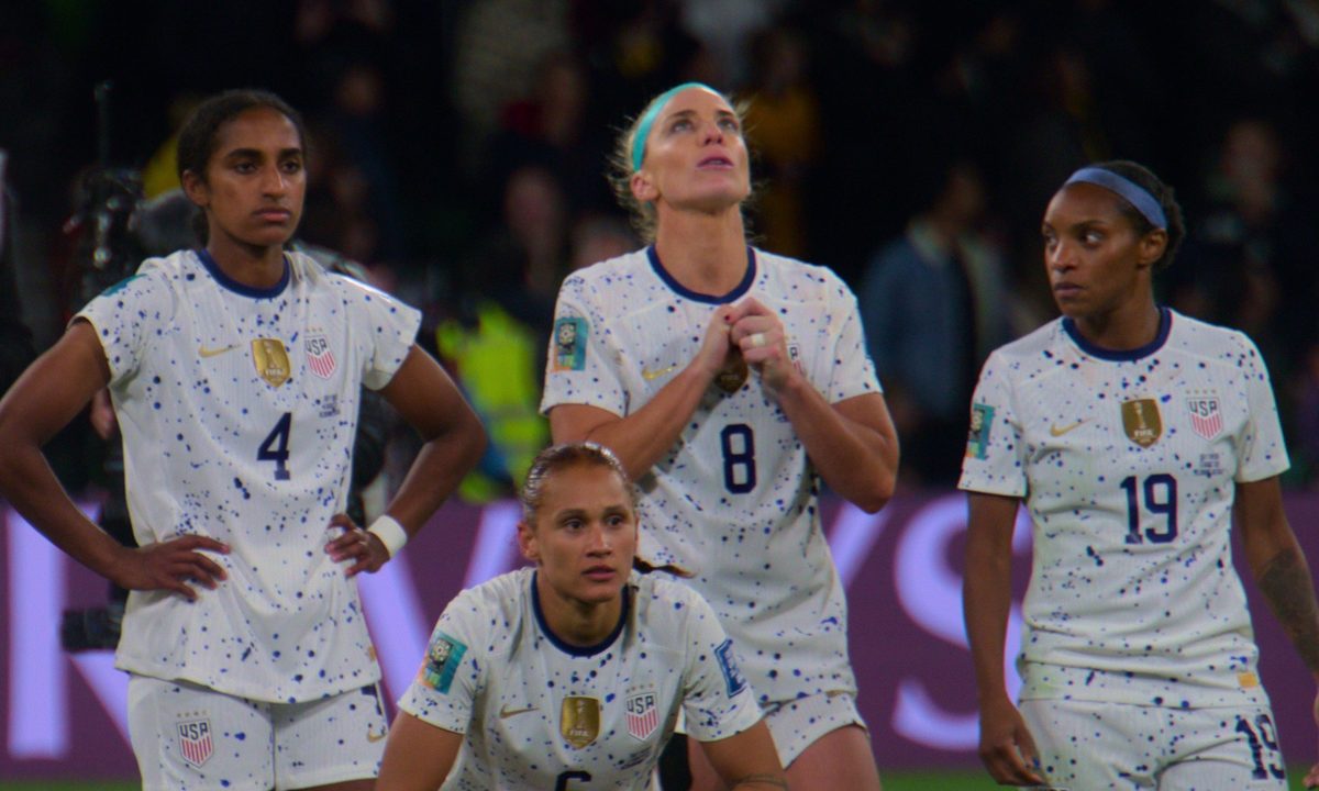 A group of women's soccer players stand in a line.