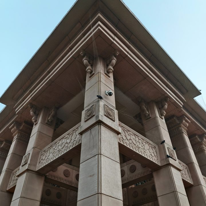 Corner of a hotel building with engraved pillars captured on the Vivo X200 Pro.