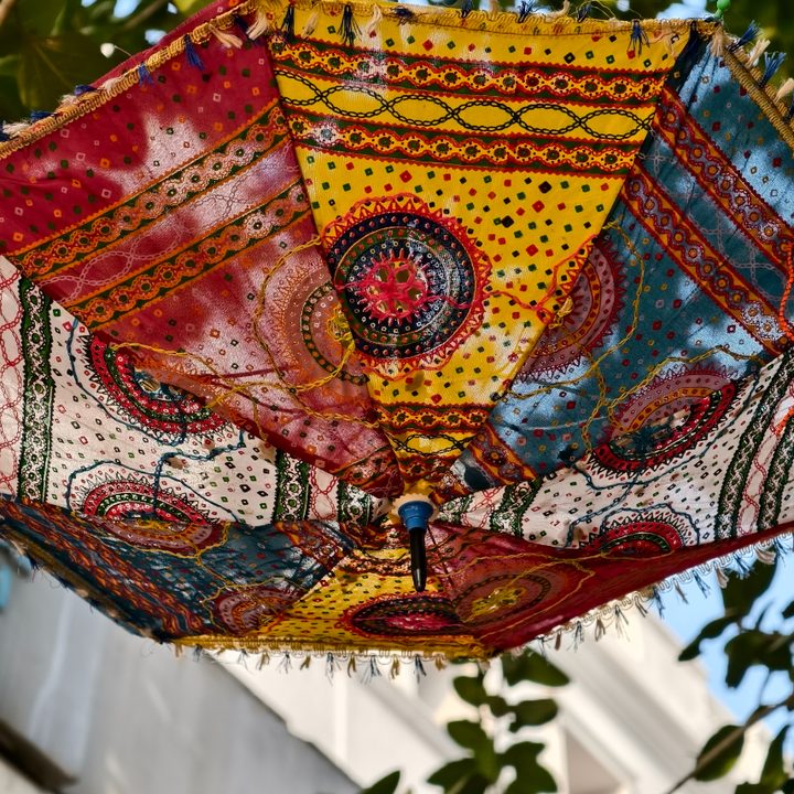 Hand woven umbrella hanging in front of the sun captured on the Vivo X200 Pro.