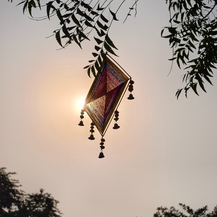 Hand woven kite hanging in front of the sun captured on the Vivo X200 Pro.