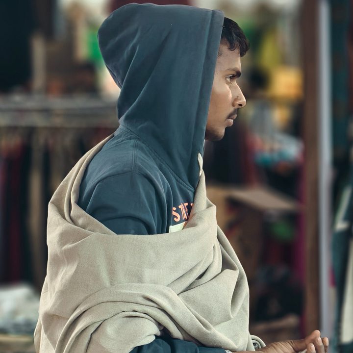 Man draped in a woolen shawl and wearing a hoodie captured with the Vivo X200 Pro.