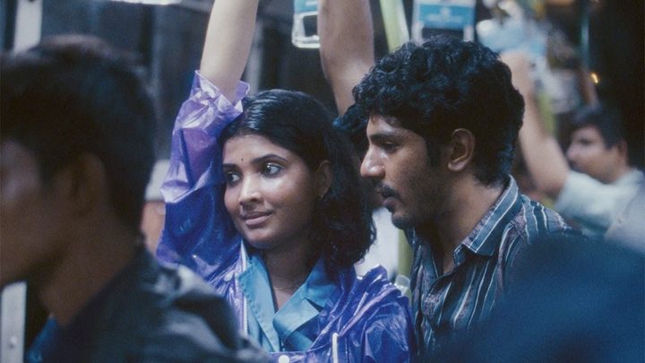 A man and a woman ride a bus in All We Imagine As Light.