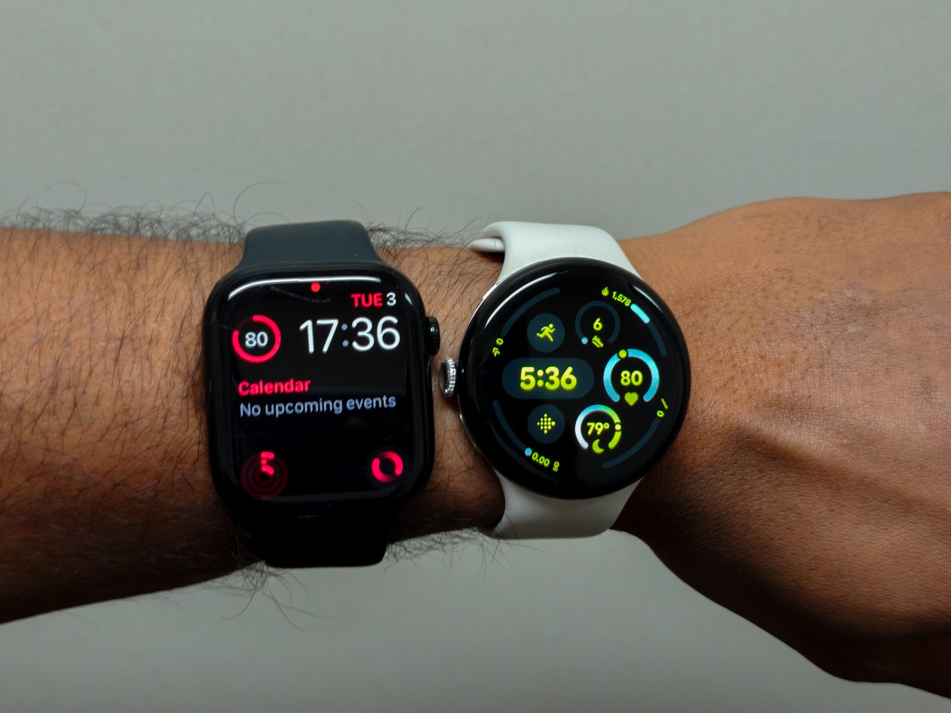The Apple Watch Series 10 and Pixel Watch 3 on one wrist