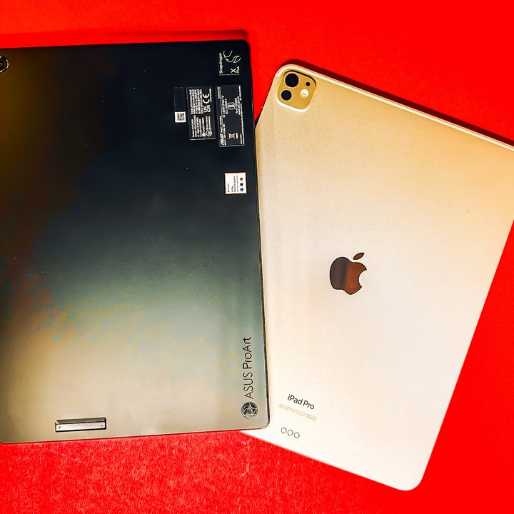 Asus ProArt PZ13 tablet resting above an iPad Pro.