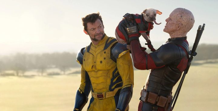 Logan looks at Wade with a dog in Deadpool & Wolverine.