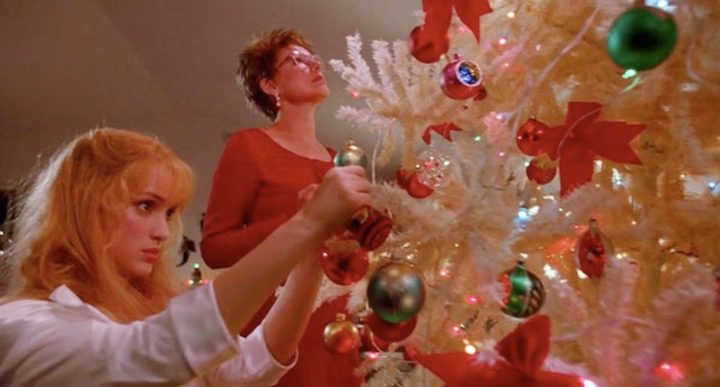 Two women decorate a Christmas tree in Edward Scissorhands.