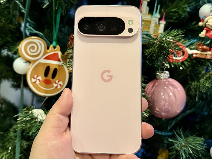 Rose Quartz Pixel 9 Pro in front of a Christmas tree.