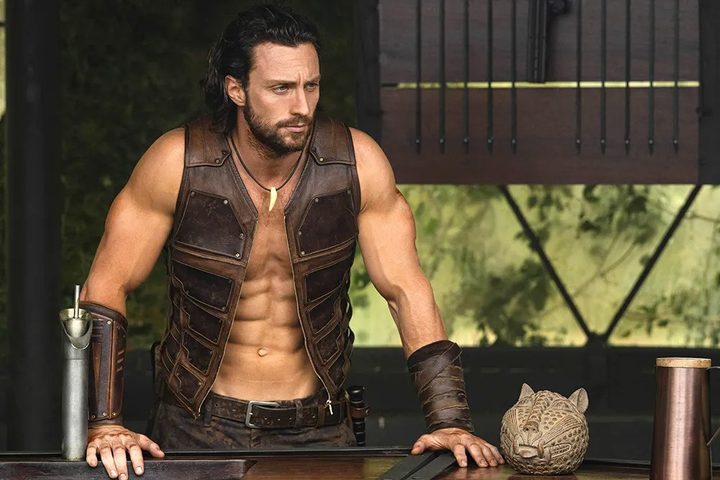 A man leans on a railing in Kraven the Hunter.