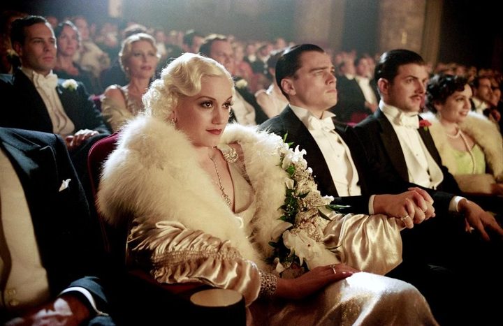 People sit in a movie theater in The Aviator.