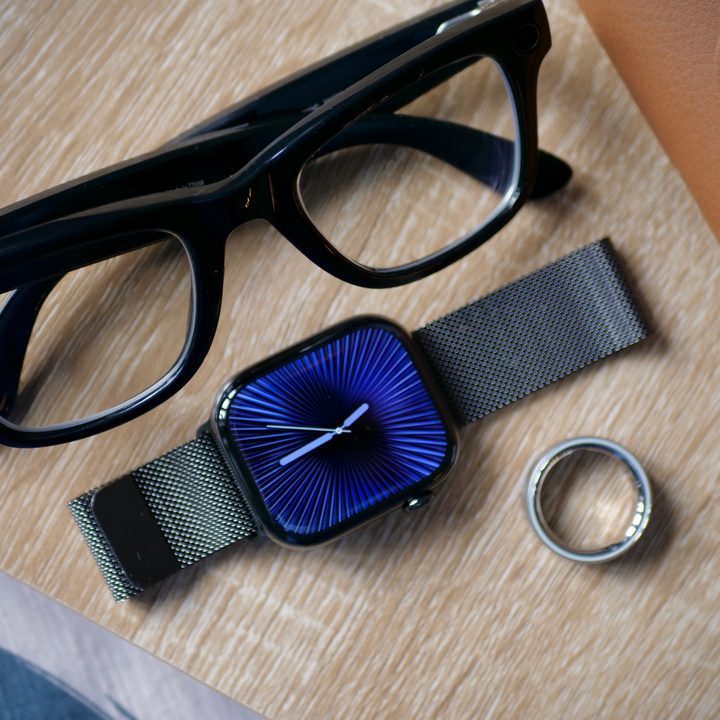 The Ray-Ban Meta smartglasses, Apple Watch Series 10, and Oura Ring 4 on a table.