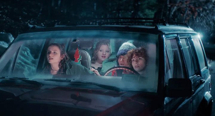 4 teens sit in a car in Christmas Eve in Miller's Point.