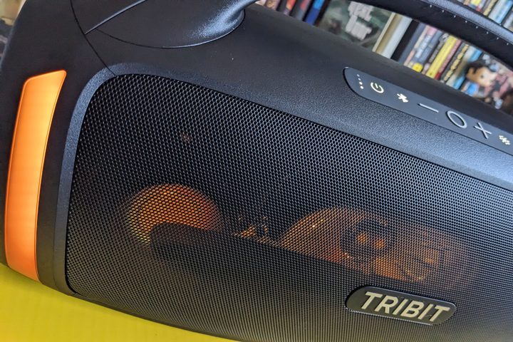 The Tribit StormBox Blast 2 with the LED lights lit up in orange.