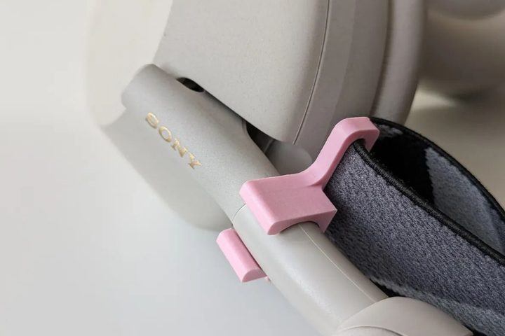 A set of 3D-printed headband holders with an replacement SteelSeries Arctis headband, attached to a set of Sony WH-1000XM5 headphones.