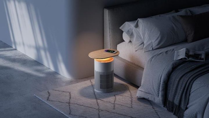 The SwitchBot Air Purifier Table near a bed.